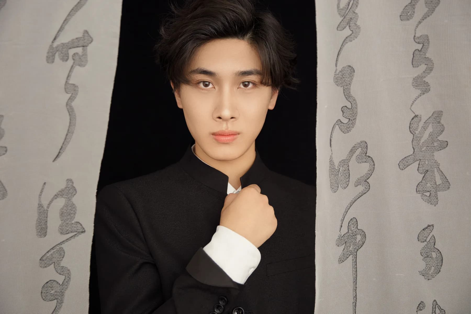 KSONG in a black suit portrait